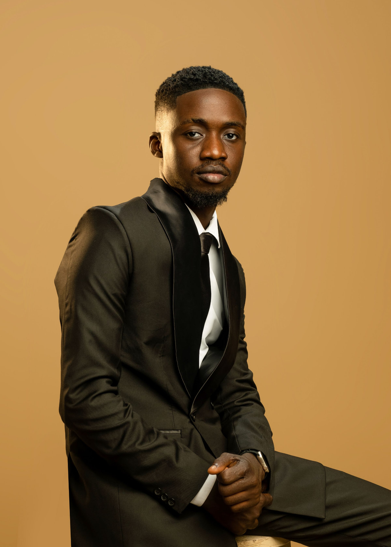 Formal portrait of a chauffeur in a tailored black suit and tie